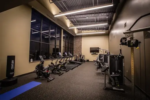 Modern fitness area with equipment at Prairie Ridge Integrated Behavioral Healthcare Mason City Main Office detox center in Iowa.