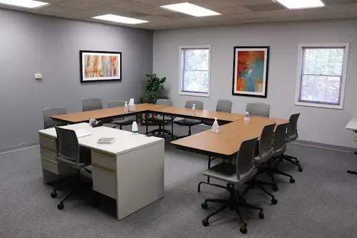 Bright meeting room with tables and chairs at Rosecrance Davenport detox center in Iowa.