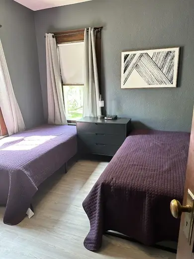 Cozy bedroom with two beds at Midwest Wellness & Recovery, a detox center in Iowa.