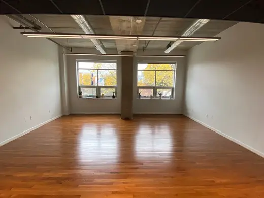 Spacious, sunlit room with hardwood floors at Seva Counseling treatment center in Iowa.